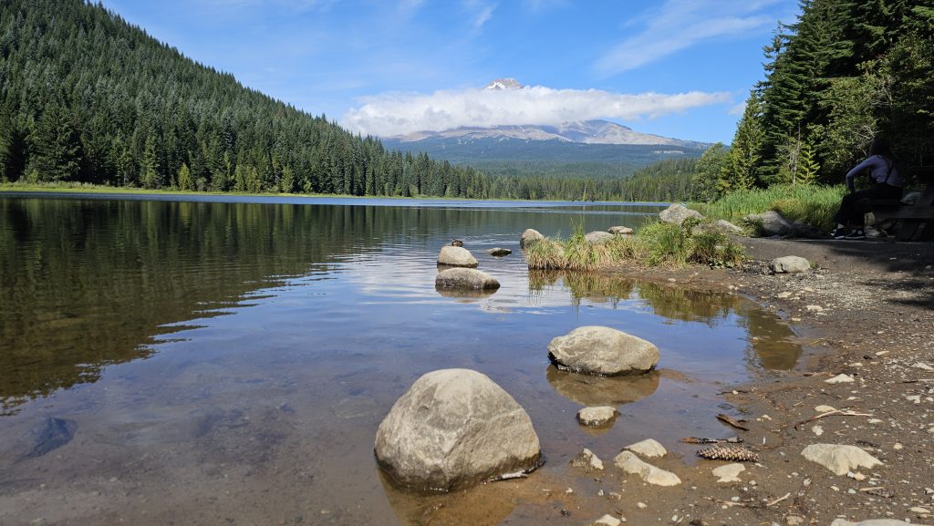 Tranquil lake at Mount Hood. with Stepping stones inviting you to Unlock and Embody your Authentic Power